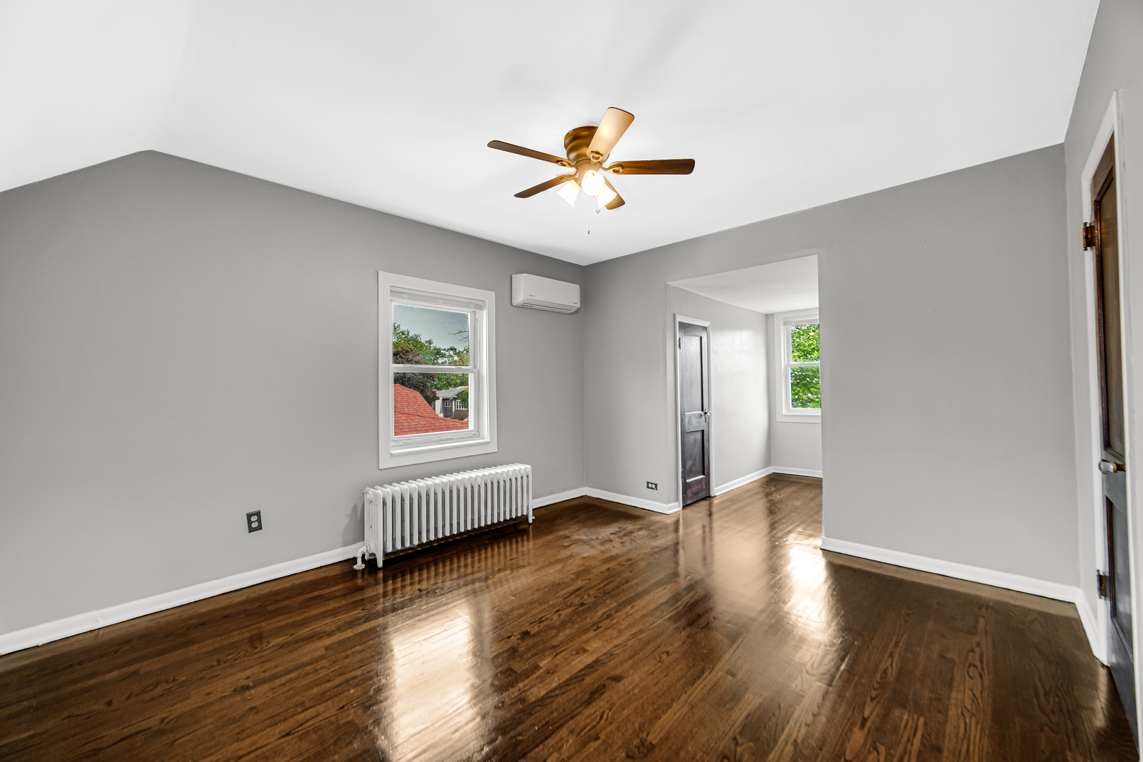 248 Ruth Street Calumet City, IL 60409 - Photo 15 of 19 an empty room with wooden floor window and ceiling fan