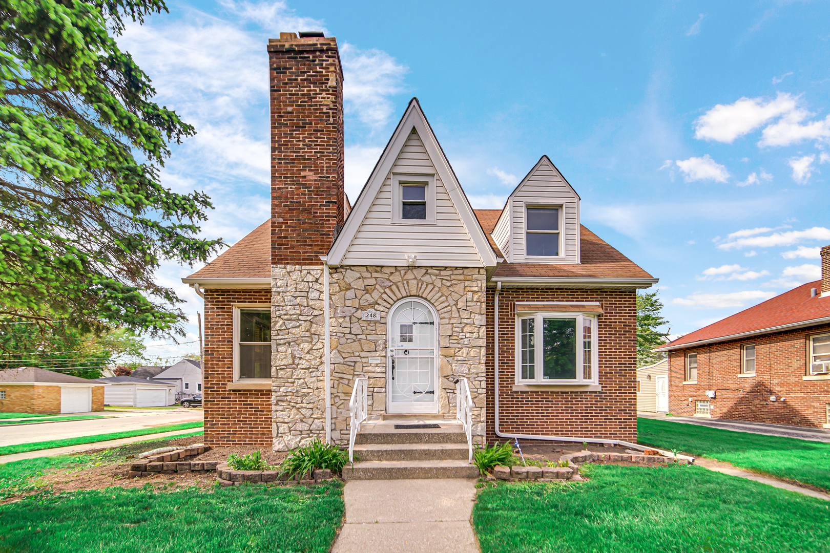 248 Ruth Street Calumet City, IL 60409 - Photo 19 of 19 a front view of a house with a garden