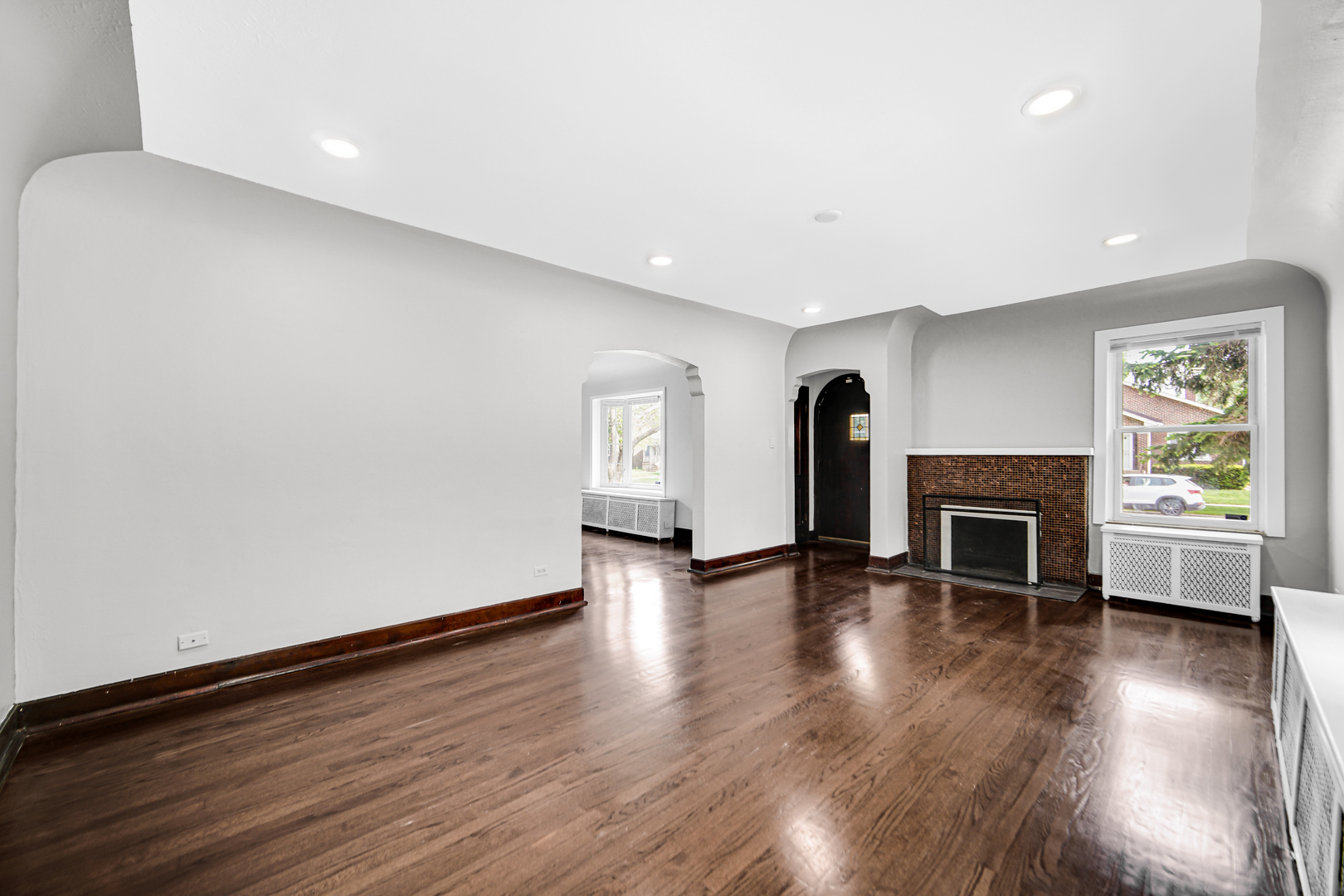 248 Ruth Street Calumet City, IL 60409 - Photo 4 of 19 a view of empty room with fireplace and wooden floor