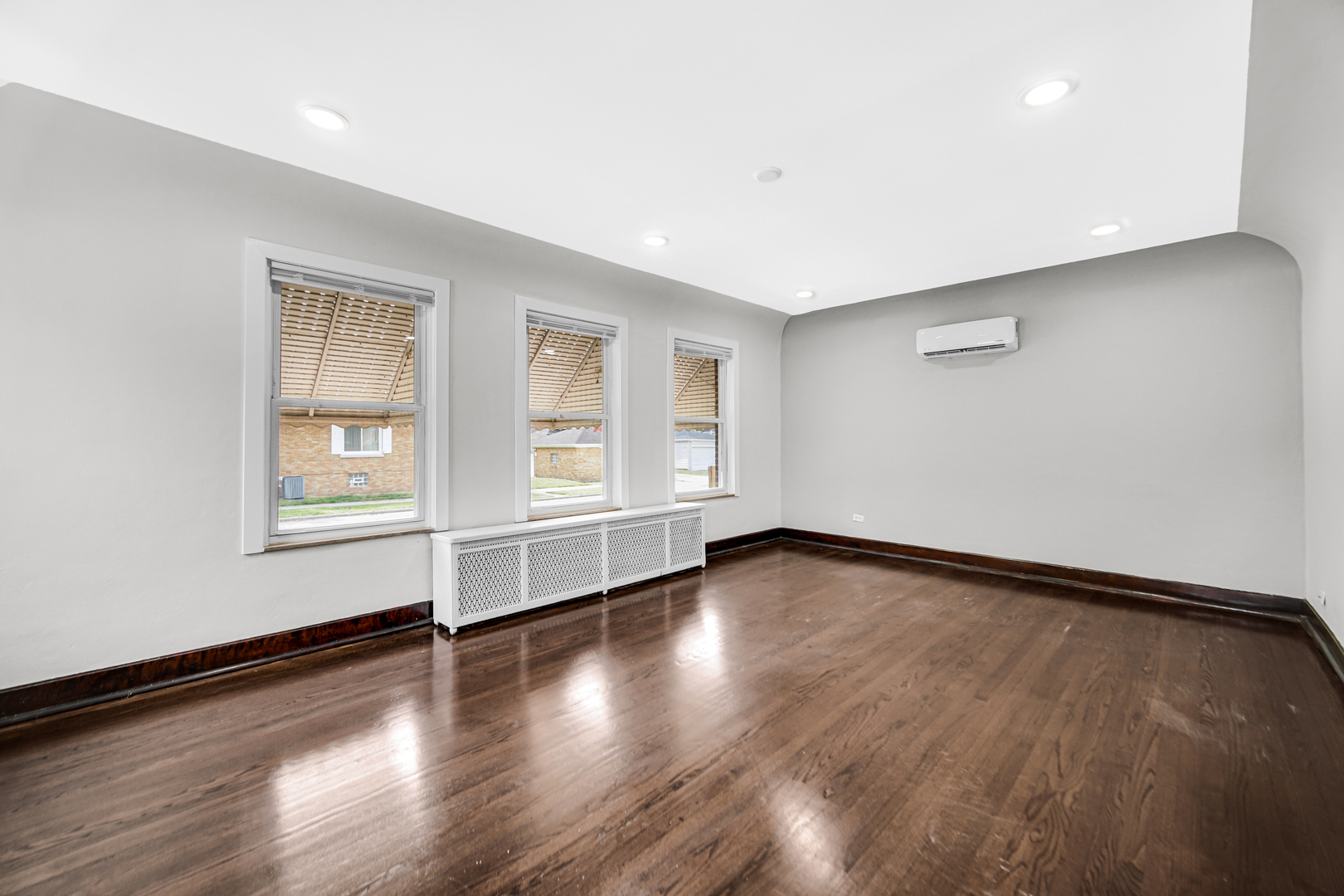 248 Ruth Street Calumet City, IL 60409 - Photo 5 of 19 an empty room with wooden floor and windows