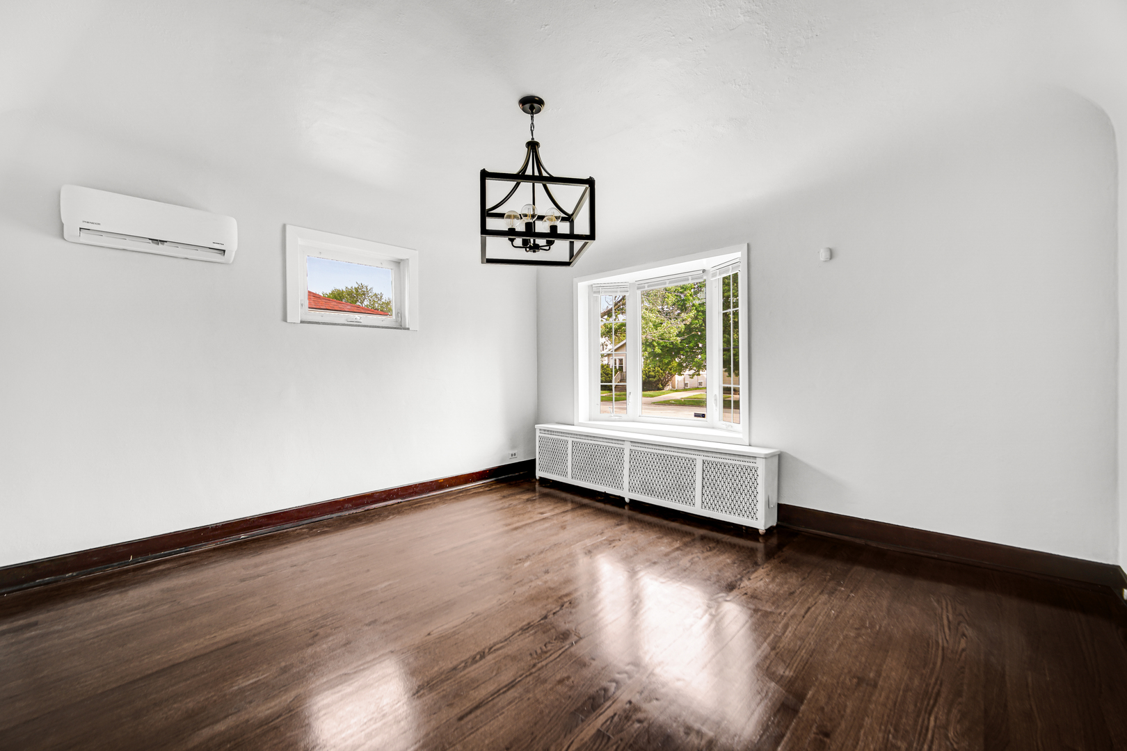 248 Ruth Street Calumet City, IL 60409 - Photo 7 of 19 a view of an empty room with wooden floor and a window