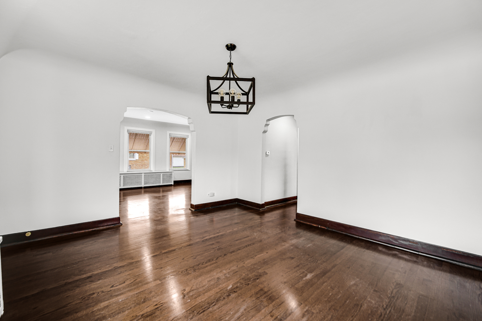 248 Ruth Street Calumet City, IL 60409 - Photo 8 of 19 a view of an empty room with wooden floor and a window