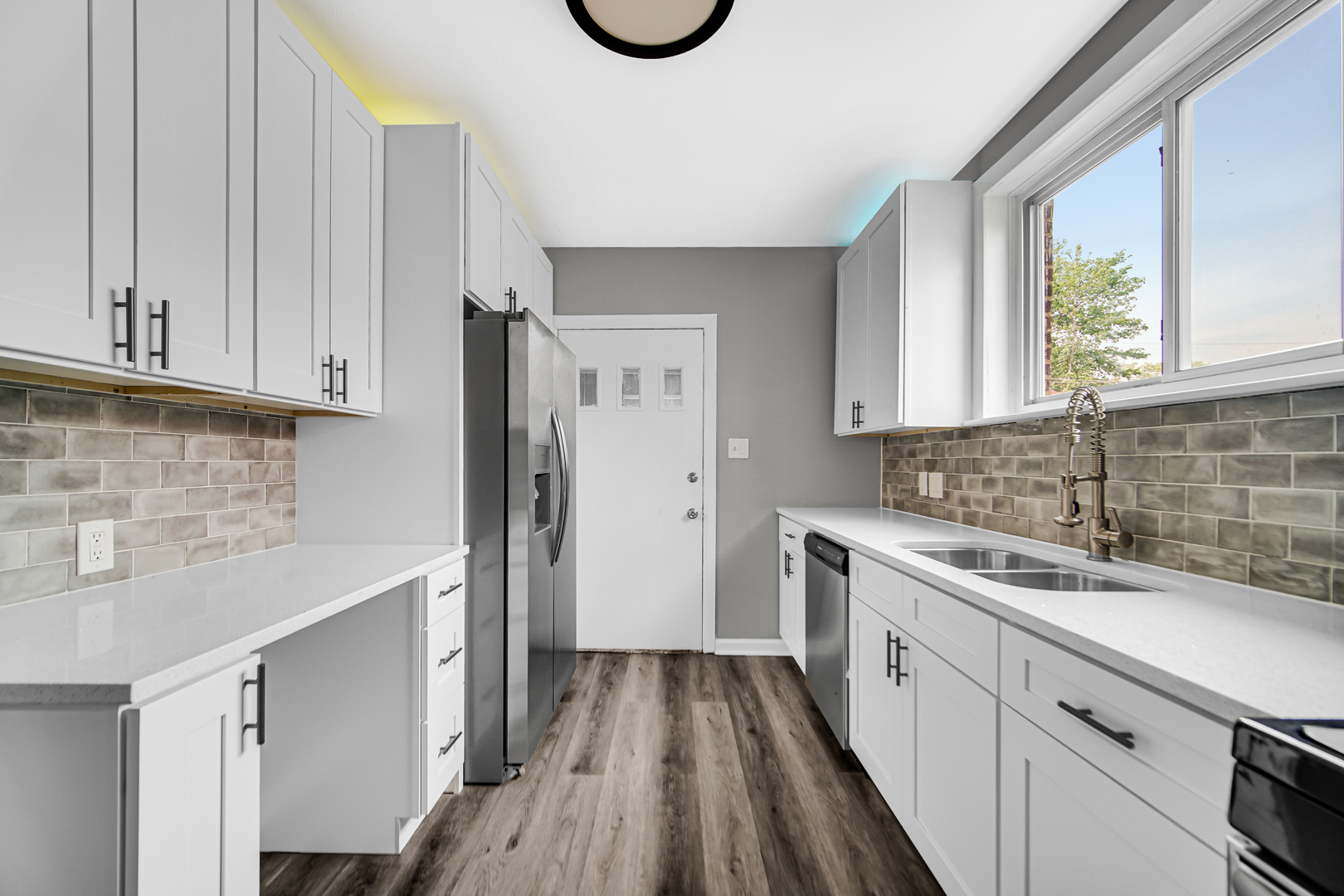 248 Ruth Street Calumet City, IL 60409 - Photo 10 of 19 a kitchen with a sink a window and cabinets
