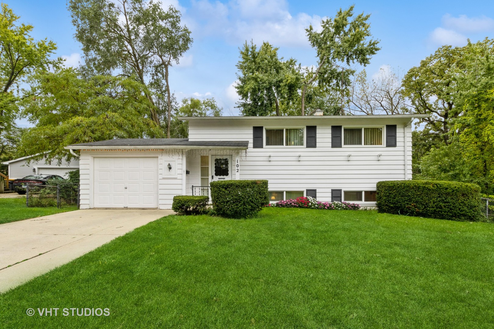 102 Big Oaks Road Streamwood, IL 60107 - Photo 1 of 11 a view of a house with a yard and potted plants
