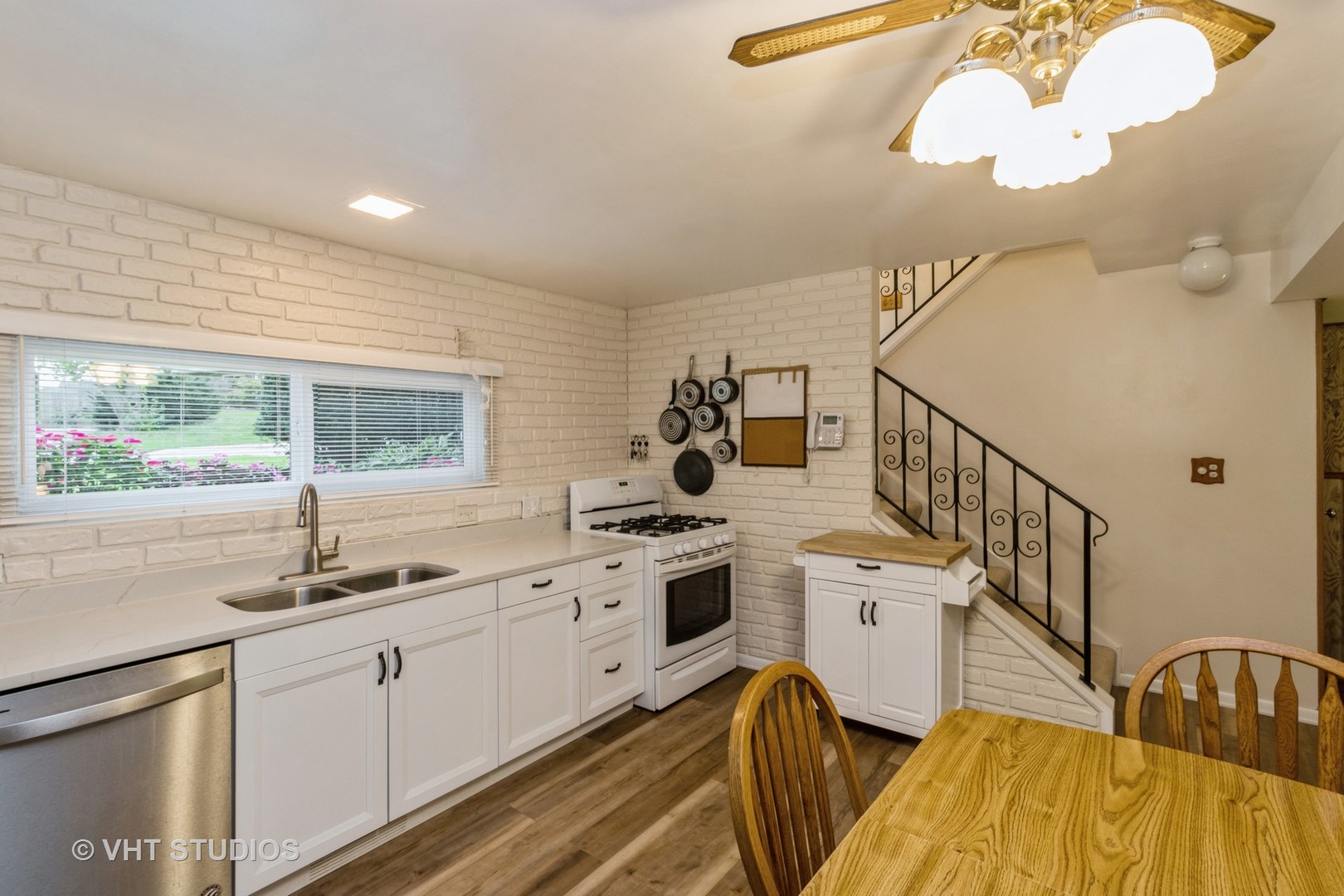 102 Big Oaks Road Streamwood, IL 60107 - Photo 4 of 11 a kitchen with sink cabinets and window