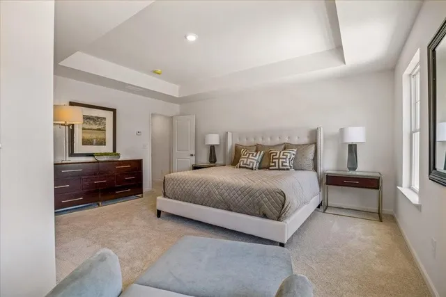 a spacious bedroom with a bed and a couch