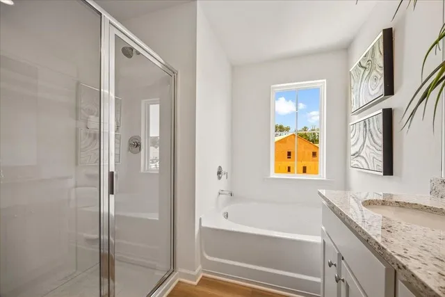 a bathroom with a granite countertop tub sink and mirror