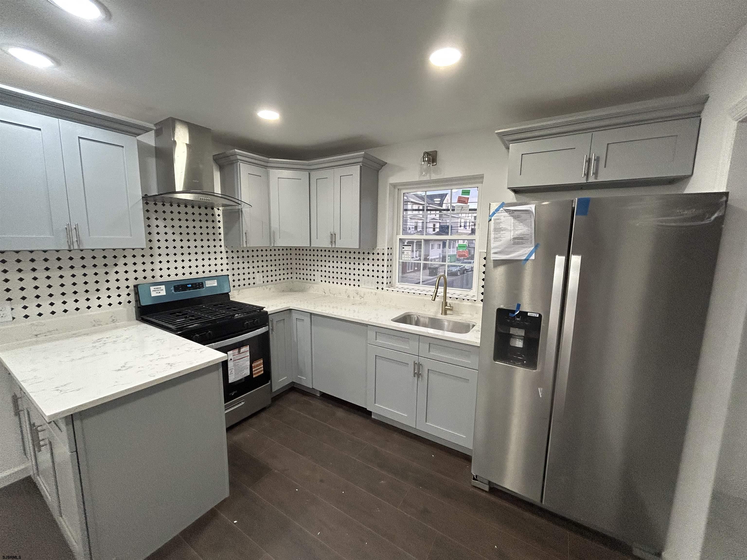 2821 Arctic Avenue, Unit 3 Atlantic City, NJ 08401 - Photo 3 of 11 a kitchen with a refrigerator sink and stove