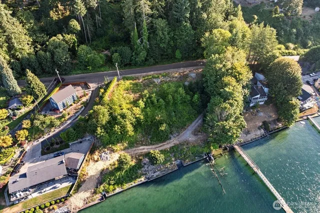an aerial view of a house with a yard basket ball court and trampoline