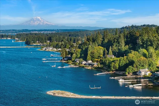 a view of a lake with lawn chairs