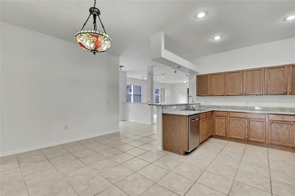 8049 Sanguinelli Road Land O Lakes, FL 34637 - Photo 14 of 45 a kitchen with stainless steel appliances granite countertop a sink and cabinets