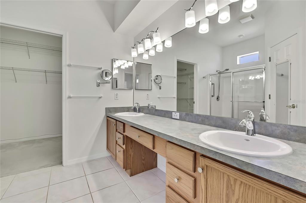 8049 Sanguinelli Road Land O Lakes, FL 34637 - Photo 21 of 45 a bathroom with a sink double vanity and a mirror
