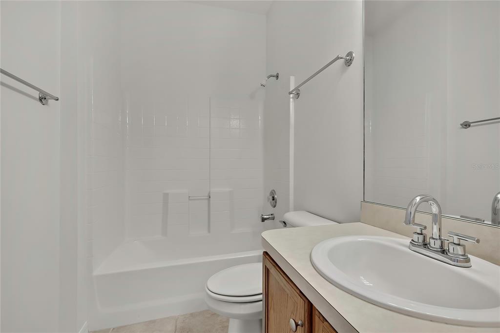 8049 Sanguinelli Road Land O Lakes, FL 34637 - Photo 31 of 45 a bathroom with a sink toilet and shower