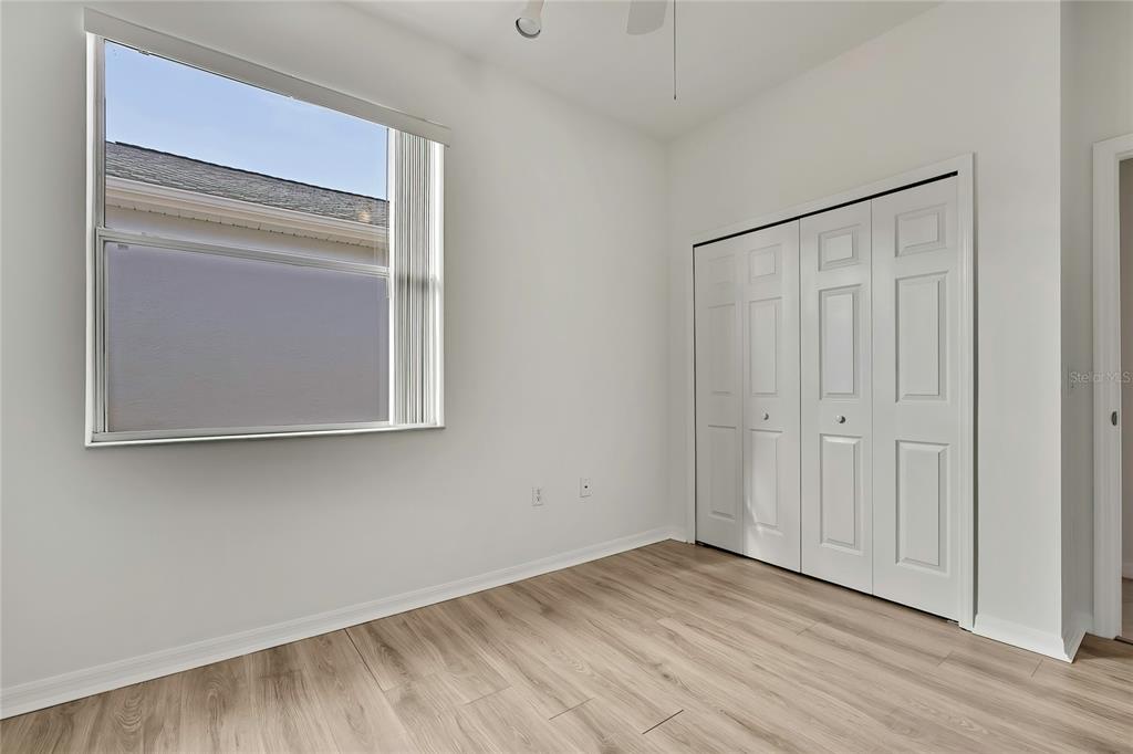 8049 Sanguinelli Road Land O Lakes, FL 34637 - Photo 33 of 45 a view of an empty room with wooden floor and closet
