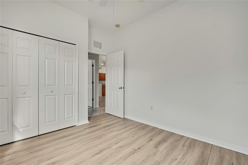 8049 Sanguinelli Road Land O Lakes, FL 34637 - Photo 34 of 45 a view of an empty room with wooden floor and a window
