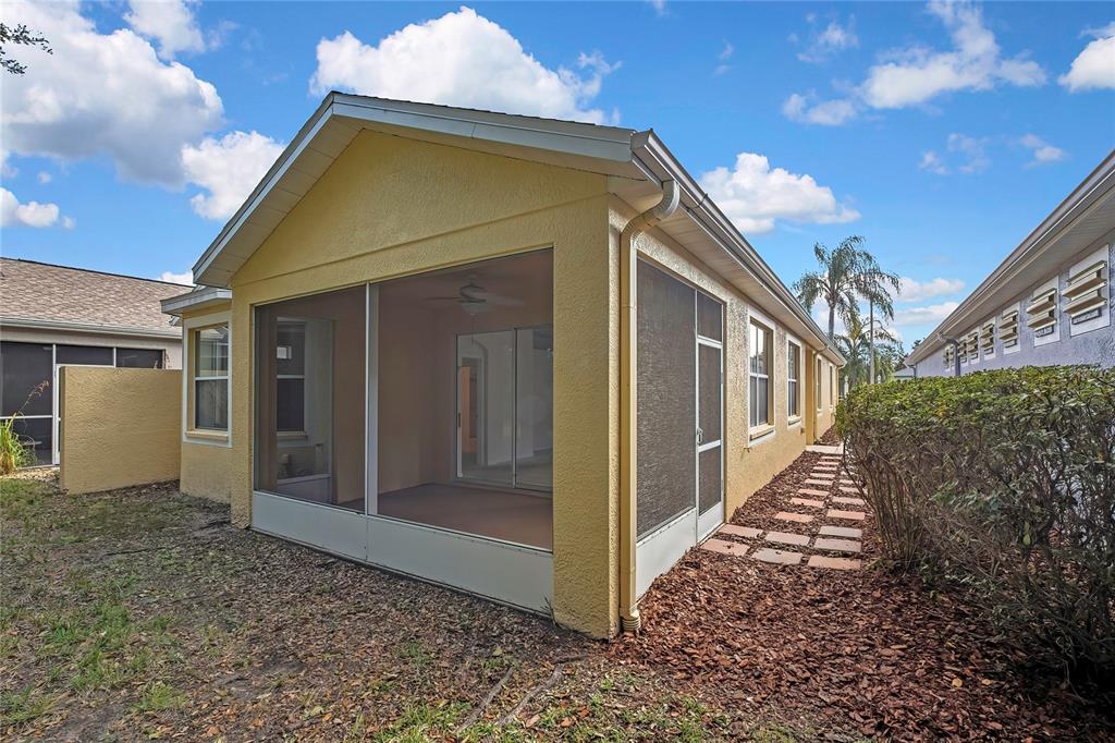 8049 Sanguinelli Road Land O Lakes, FL 34637 - Photo 45 of 45 a view of a small house with wooden fence