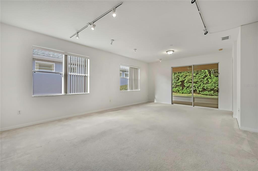 8049 Sanguinelli Road Land O Lakes, FL 34637 - Photo 5 of 45 an empty room with windows