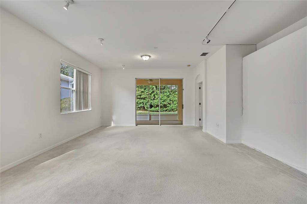 8049 Sanguinelli Road Land O Lakes, FL 34637 - Photo 6 of 45 a view of an empty room with a window