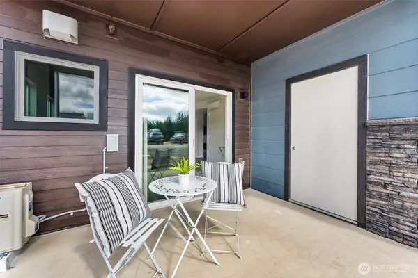 a view of a porch with furniture and a yard