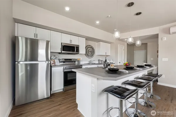 a kitchen with a refrigerator a stove a sink and a microwave