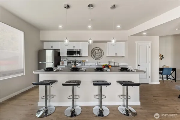 a kitchen with sink a table and chairs