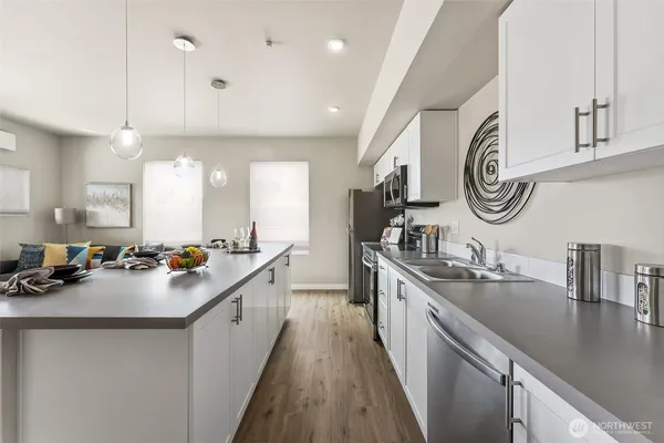 a kitchen with sink stove and cabinets