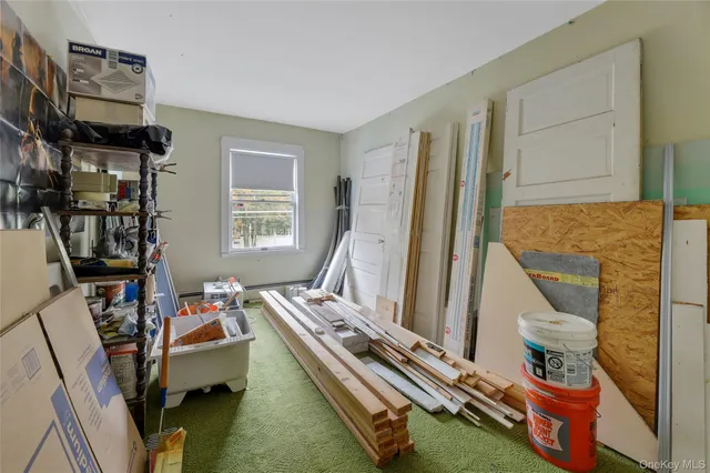 a room with furniture a flat screen tv and a window