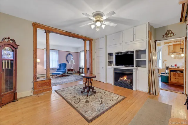 a living room with fireplace furniture and a flat screen tv