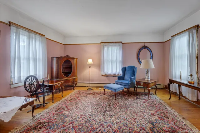 a living room with furniture a window and a flat screen tv