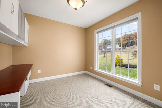 a view of an empty room with glass door