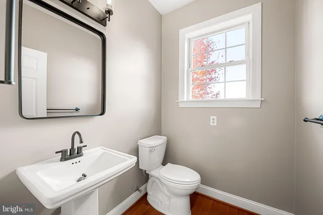 a room with water heater and a view of kitchen