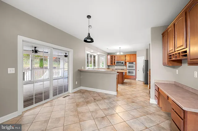 a kitchen with stainless steel appliances granite countertop a sink a stove and a refrigerator