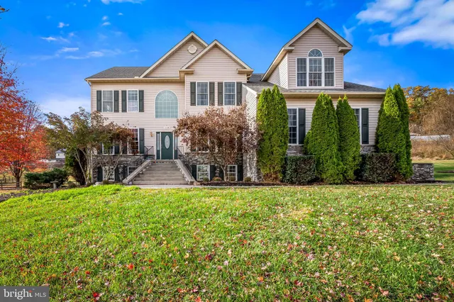a view of entryway with wooden floor and stairs