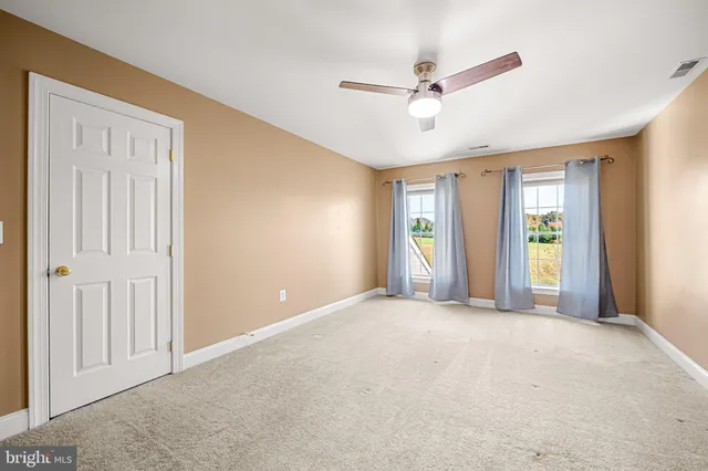 a spacious bathroom with a tub sink and mirror