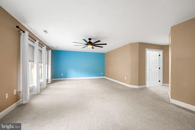 an empty room with a empty space and windows