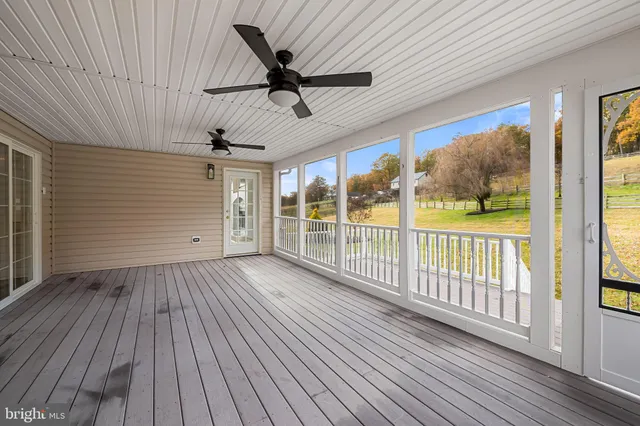 a view of a house with a big yard and large trees