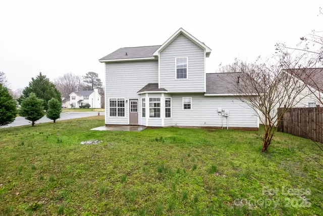 a view of a house with a backyard