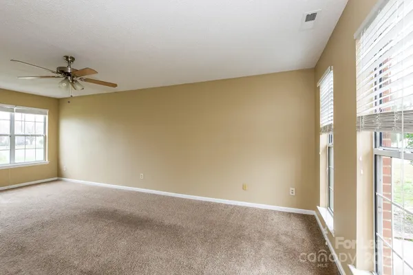 a view of an empty room and a window
