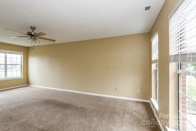 a view of an empty room and a window