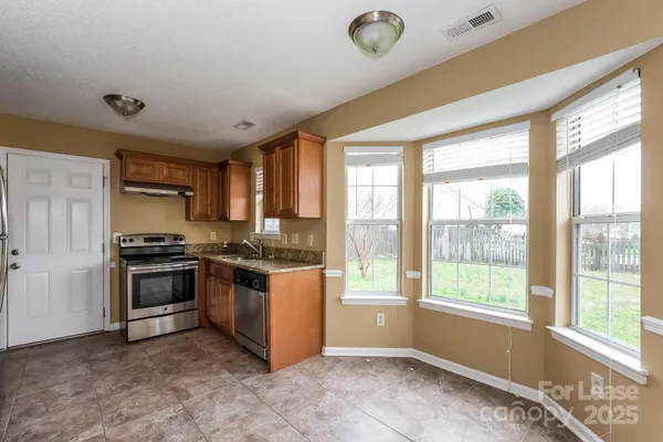 a kitchen with stainless steel appliances granite countertop a stove and a sink