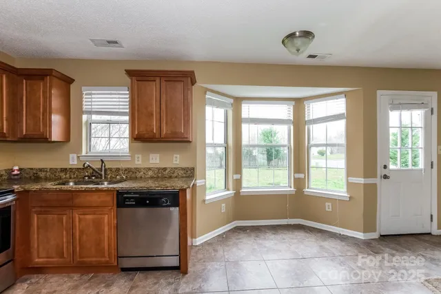 a kitchen with a stove a sink and a microwave
