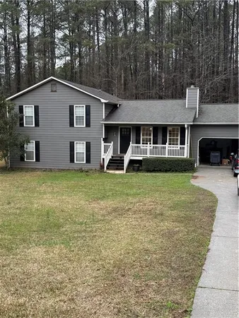 a view of a house with a yard and sitting area