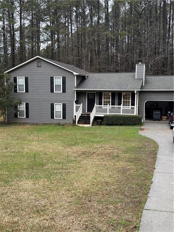 a view of a house with a yard and sitting area