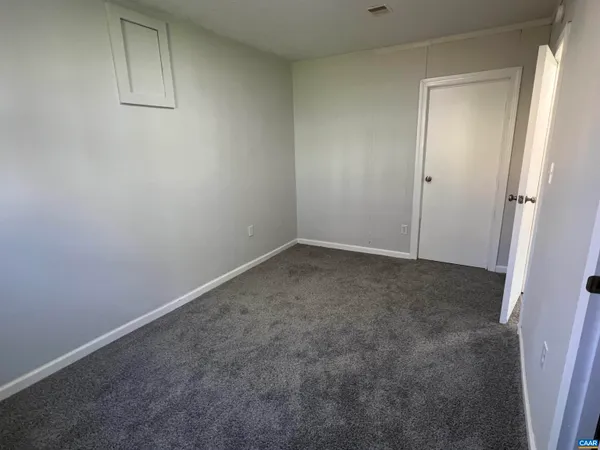 an empty room with an entrance to other room