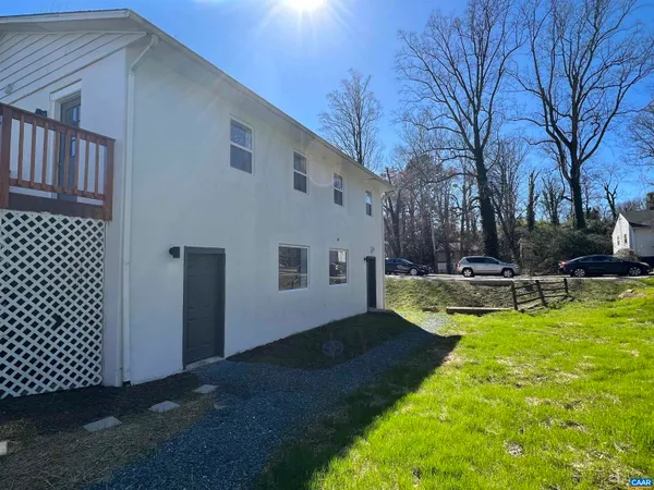 a view of a house with backyard porch and sitting area