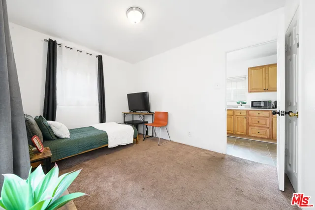 a bedroom with furniture and a flat screen tv