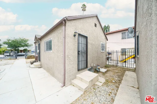 a front view of a house with outdoor seating