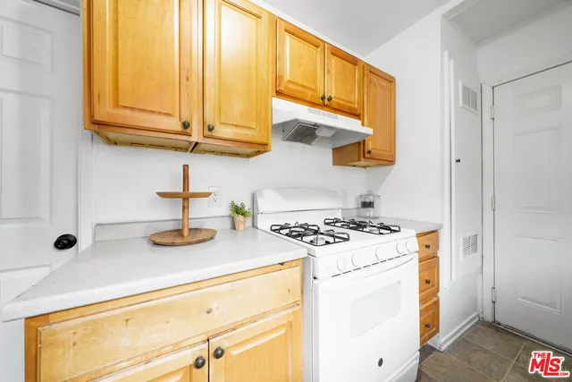 a kitchen with stainless steel appliances granite countertop a sink and a stove