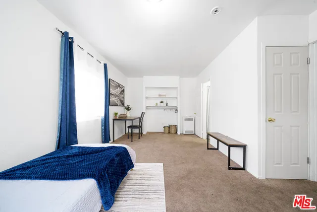 a bedroom with furniture and a window