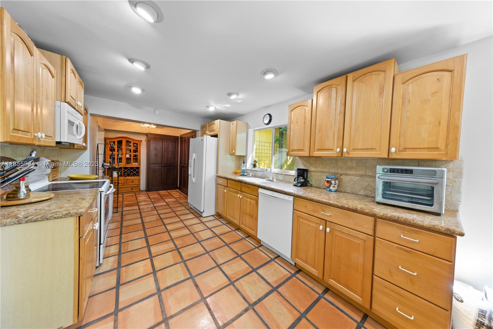 Redlands Homestead, FL 33031 - Photo 11 of 31 a large kitchen with stainless steel appliances granite countertop a stove top oven a sink dishwasher and cabinets with wooden floor
